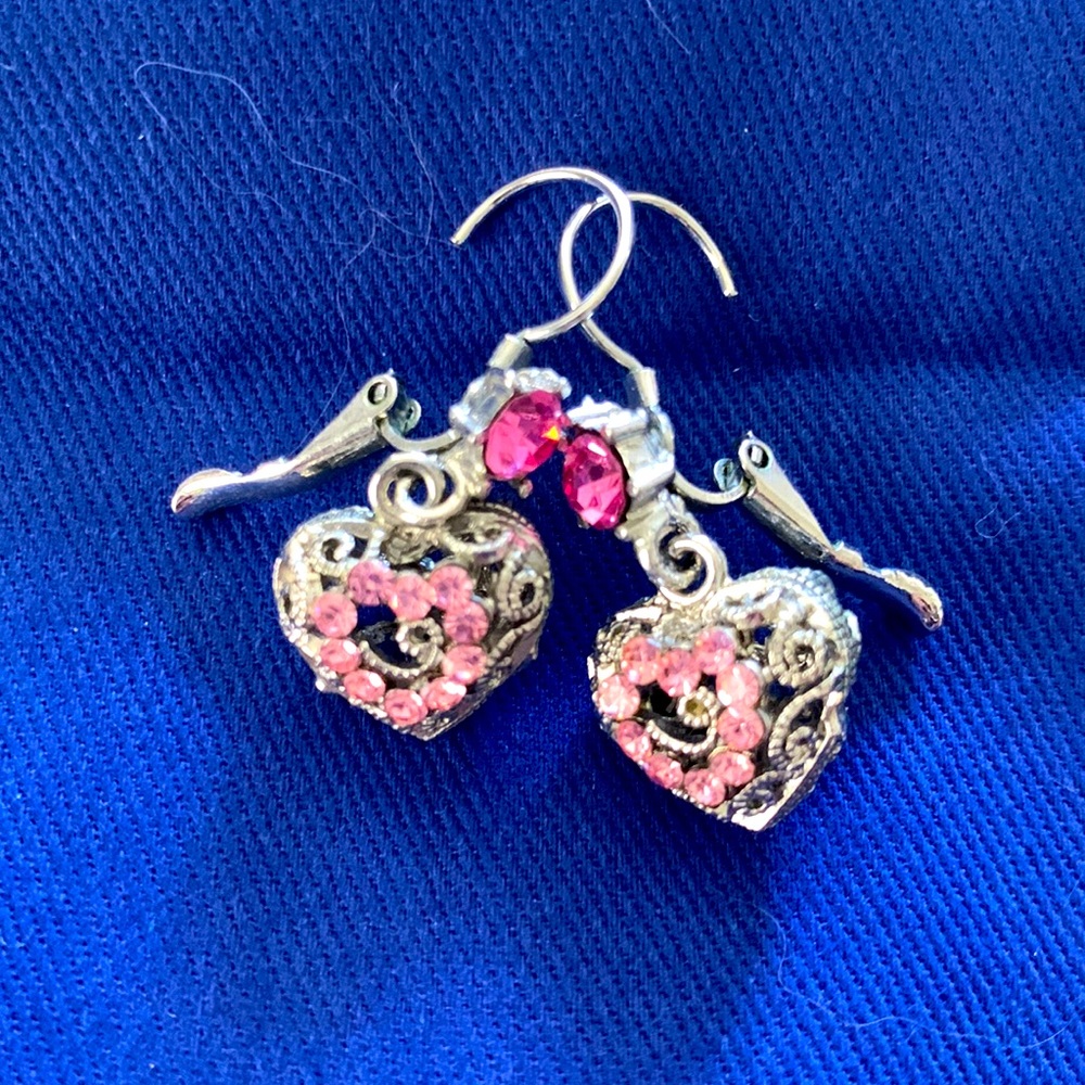 Delicate pink and silver heart earrings.